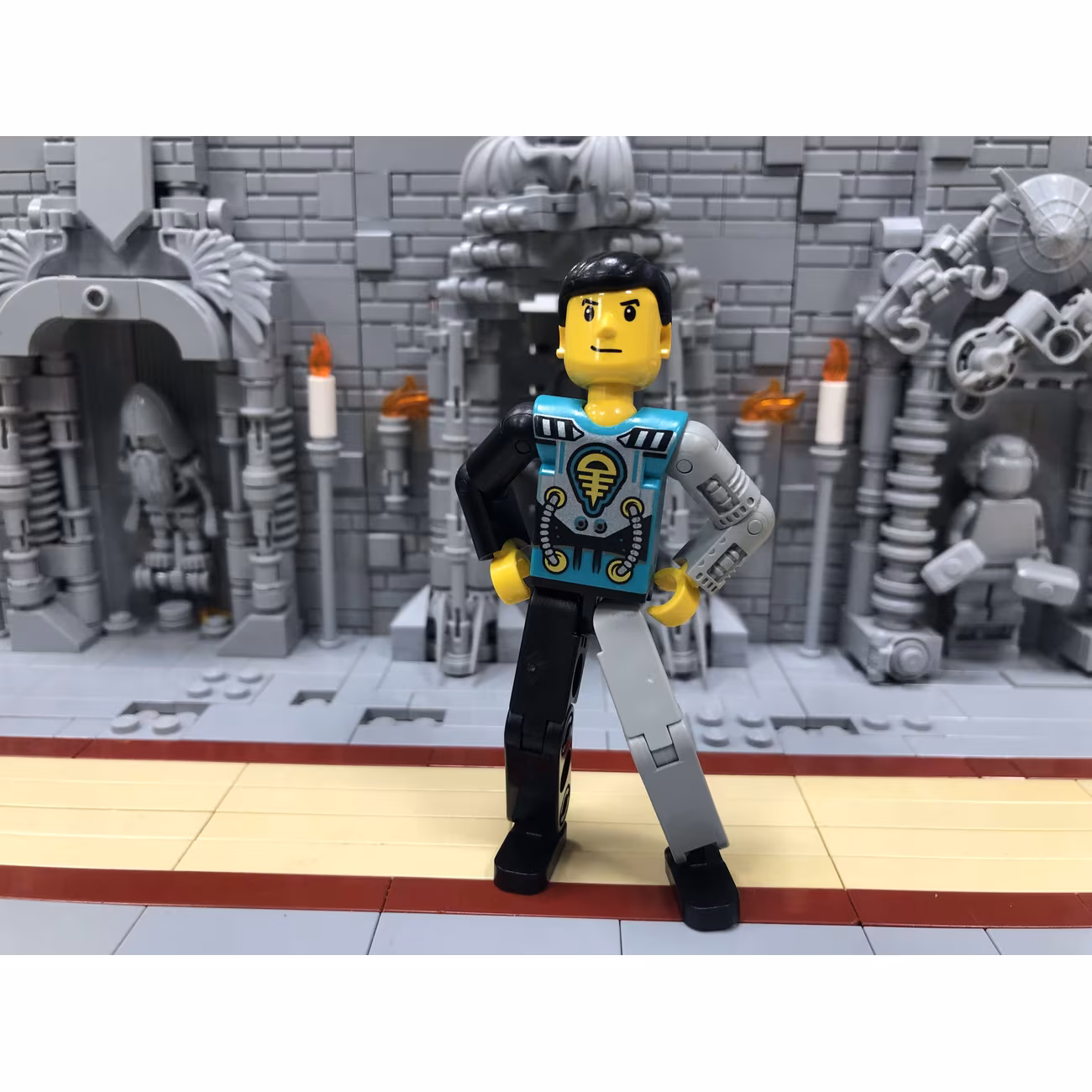 Technic Figure Black/Light Gray Legs, Dark Turquoise Torso with Yellow, Black, Silver Pattern, Light Gray Mechanical Left Arm Technic Figure Black/Light Gray Legs, Dark Turquoise Torso with Yellow, Black, Silver Pattern, Light Gray Mechanical Left Arm