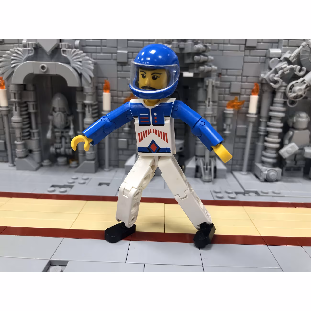 Technic Figure White Legs, White Top with Red Arrow-Type Stripes Pattern, Blue Arms, Blue Helmet Technic Figure White Legs, White Top with Red Arrow-Type Stripes Pattern, Blue Arms, Blue Helmet