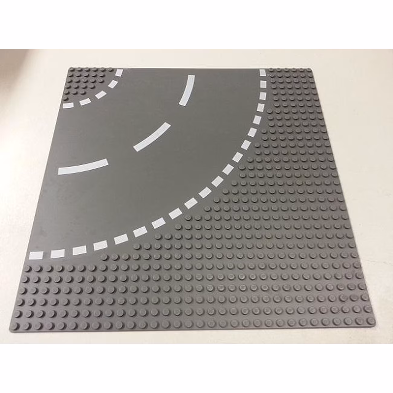 Baseplate, Road 32 x 32 6-Stud Curve with White Dashed Lines Pattern Baseplate, Road 32 x 32 6-Stud Curve with White Dashed Lines Pattern