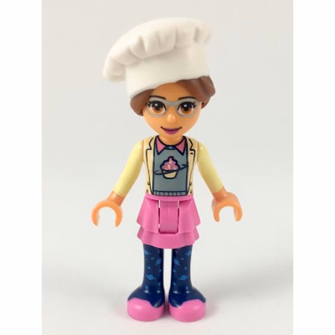 Friends Olivia (Nougat) - Dark Pink Skirt and Dark Blue Leggings, Sand Green Sweater with Bright Yellow Jacket, White Chef Toque with Hair Friends Olivia (Nougat) - Dark Pink Skirt and Dark Blue Leggings, Sand Green Sweater with Bright Yellow Jacket, White Chef Toque with Hair