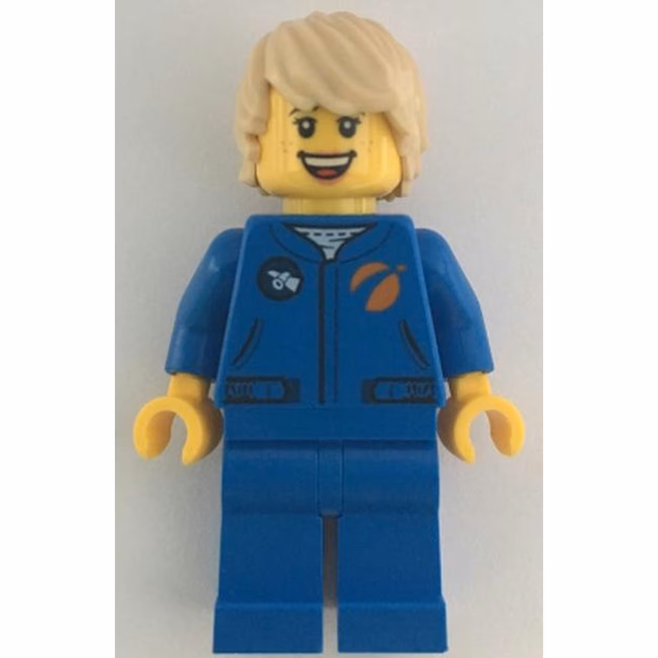 Astronaut - Female, Blue Jumpsuit, Tan Hair Tousled with Side Part, Freckles, Open Mouth Smile Astronaut - Female, Blue Jumpsuit, Tan Hair Tousled with Side Part, Freckles, Open Mouth Smile
